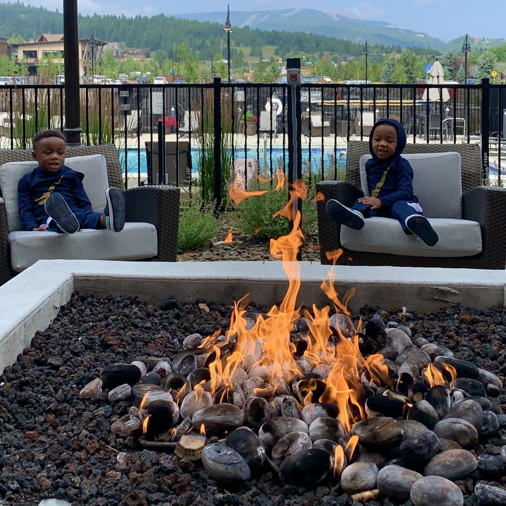 Twin boys sitting at the Wilson Hotel during their Bozeman to Yellowstone road trip.
