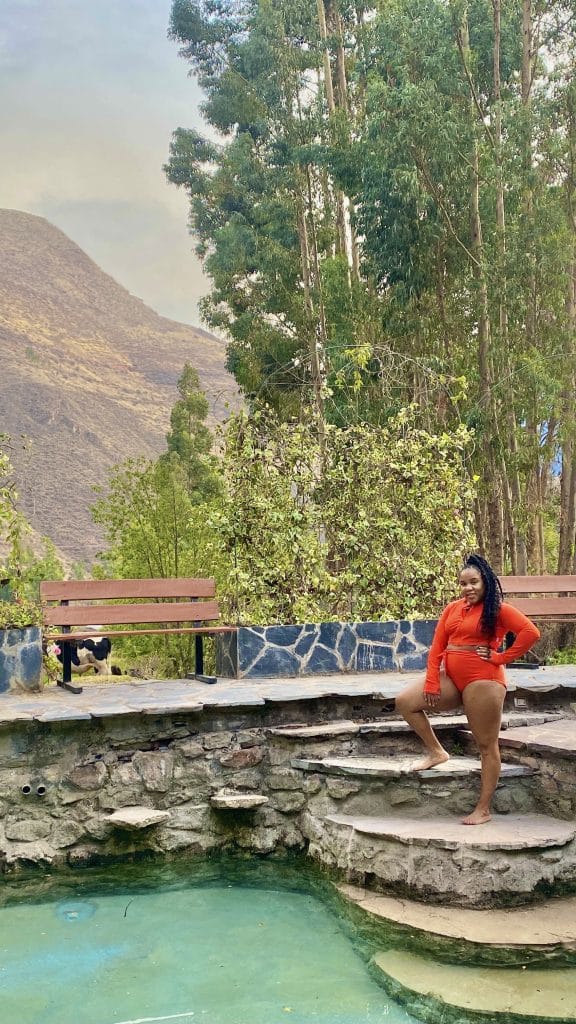 A woman enjoying summer in Peru with the backdrop of the mountains.