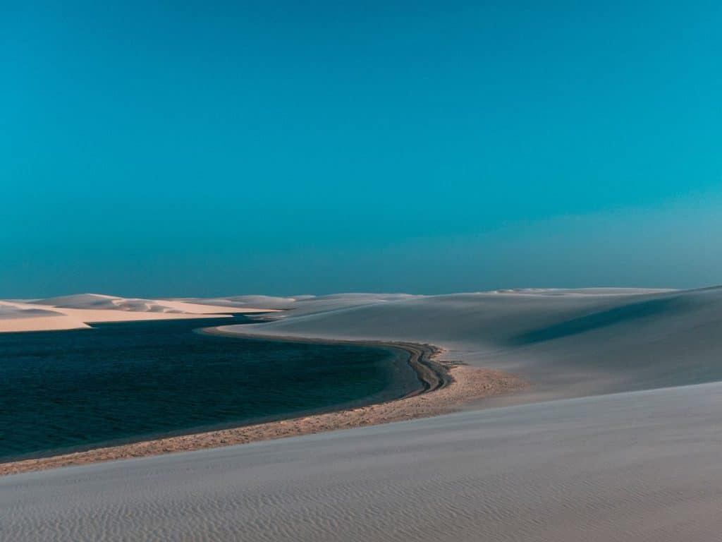Beautiufl blue lagoon nestled in between sand dunes in Lencois Maranhenses National Park in Northeast Brazil 