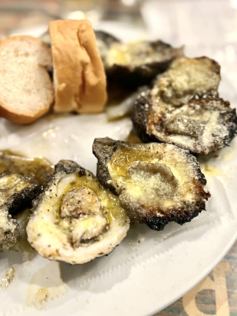 Plate of chargrilled oysters- a popular dish to get when visiting New Orleans