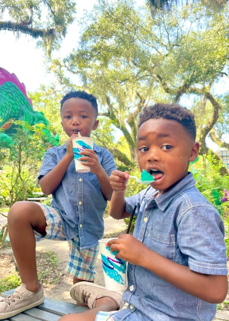 The boys enjoying blue snow cones during a sunny day in New Orleans. 