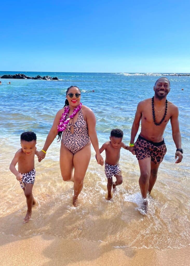 My family and I enjoying time in the sea at Poipu Beach,a must-see beach included in our Kauai 3 day itinerary.