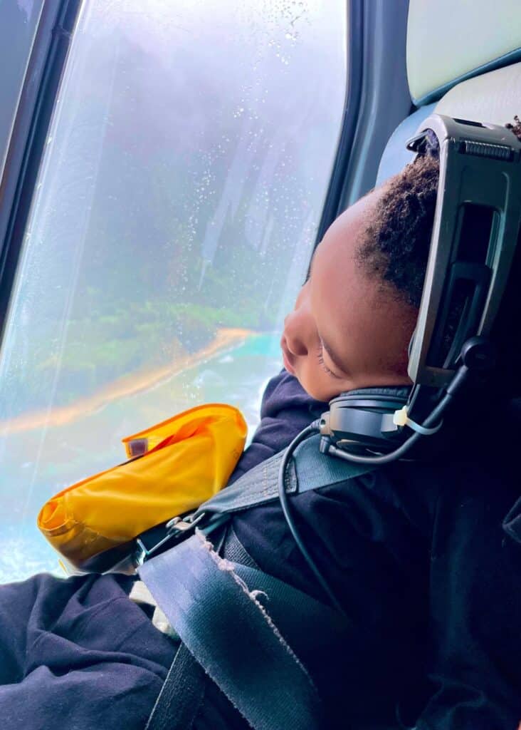 My son asleep during the helicopter tour, missing some of Kauai's most incredible sights