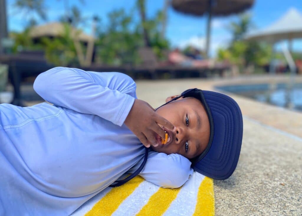 My son chilling by the pool at hour hotel in Kauai