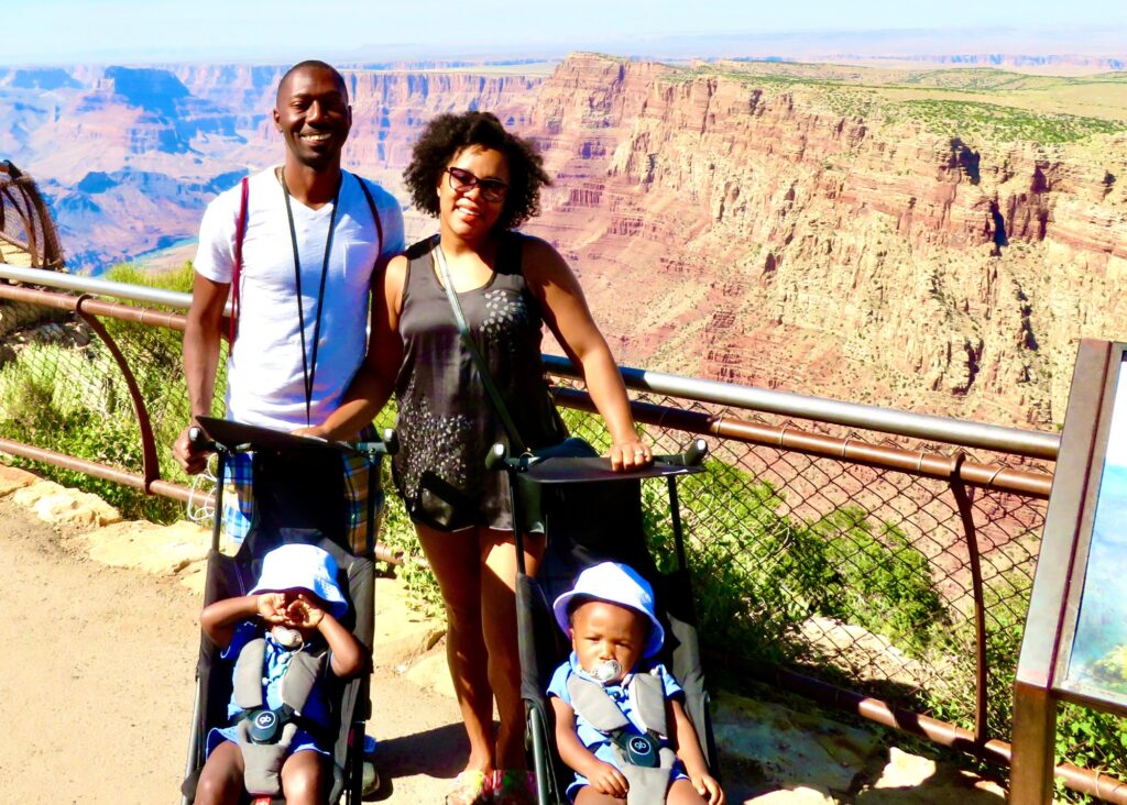 My husband and I on our Grand Canyon Day trip from Sedona posing on the South Rim Trail with the boys in their strollers. 