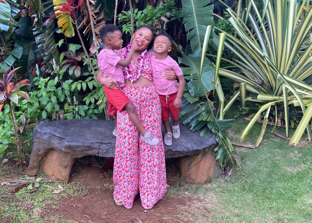 Me and the boys smiling for the camera. I'm wearing a pink and red matching set. If you're wondering what to pack for Colombia, bring plenty of 2-piece sets.