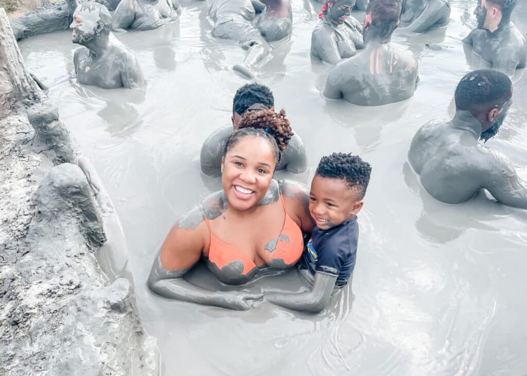 Me and my son smiling in the mud volcano—this is definitely one of the best day trips from Cartagena.