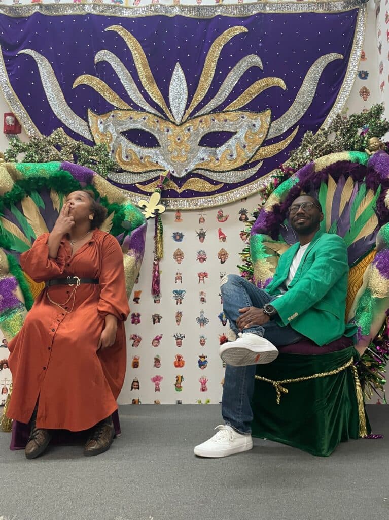 My husband and I sitting in purple, gold, and green chairs at Jamnola.