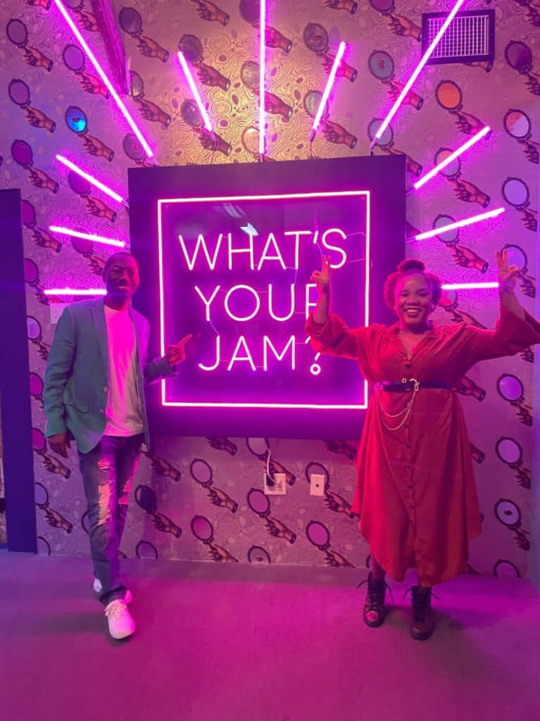 My husband and I in front of the "What's your jam?" sign at Jamnola.